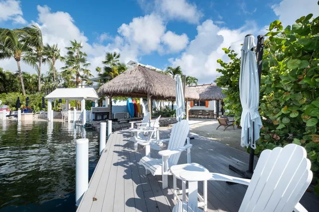 a view of a patio with table and chairs and potted plants