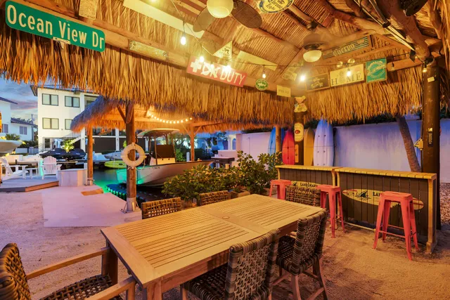 a backyard of a house with table and chairs