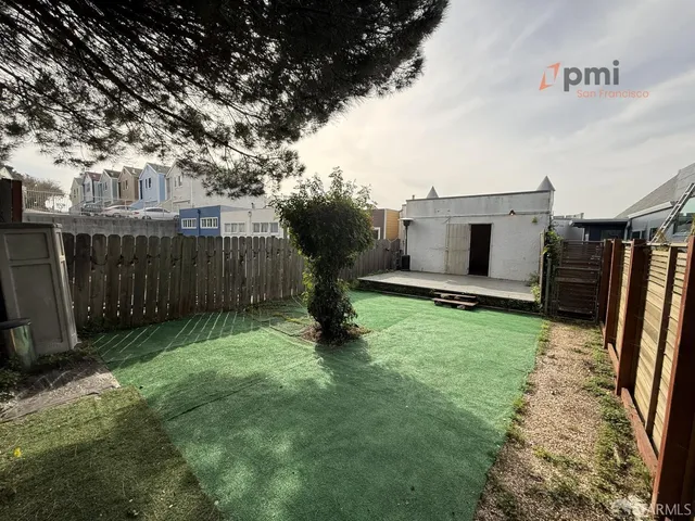 a view of a backyard with a fence