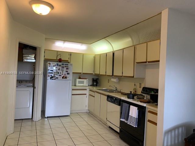 513 Racquet Club Road, Unit 55 Weston, FL 33326 - Photo 7 of 25 a kitchen with a sink a refrigerator and cabinets
