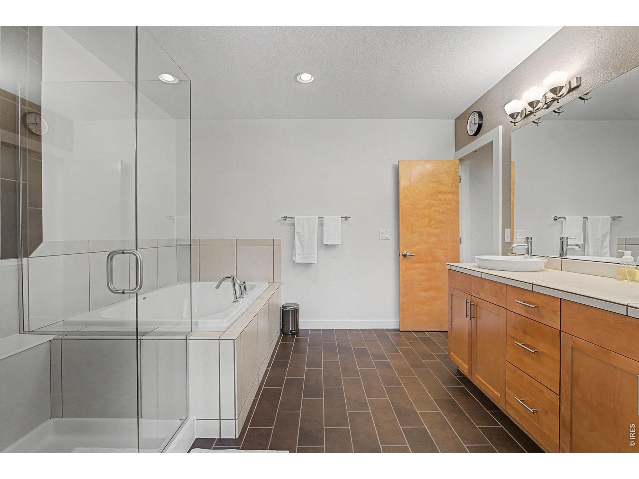 5055 Ralston Street, Unit A Boulder, CO 80304 - Photo 20 of 50 a bathroom with a sink a toilet a large mirror and shower