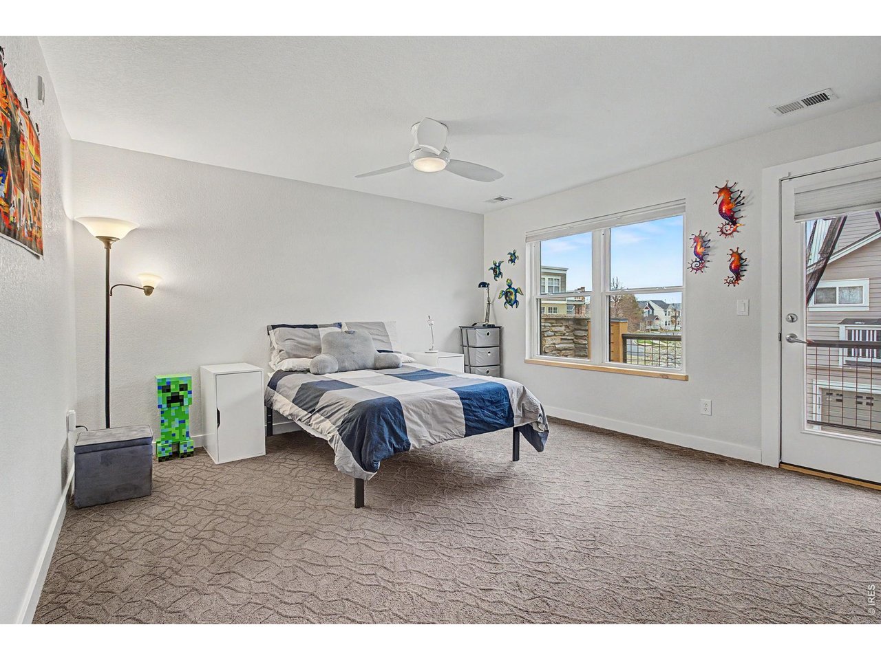 5055 Ralston Street, Unit A Boulder, CO 80304 - Photo 23 of 50 a spacious bedroom with a bed a dresser and windows