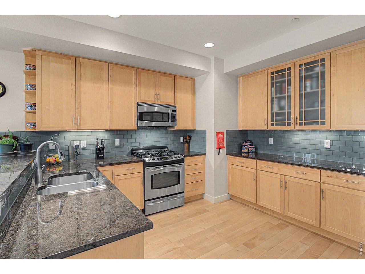 5055 Ralston Street, Unit A Boulder, CO 80304 - Photo 3 of 50 a kitchen with stainless steel appliances granite countertop a stove a sink and a microwave