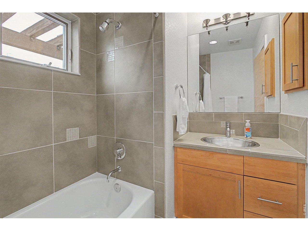 5055 Ralston Street, Unit A Boulder, CO 80304 - Photo 31 of 50 a bathroom with a granite countertop sink a mirror and a shower