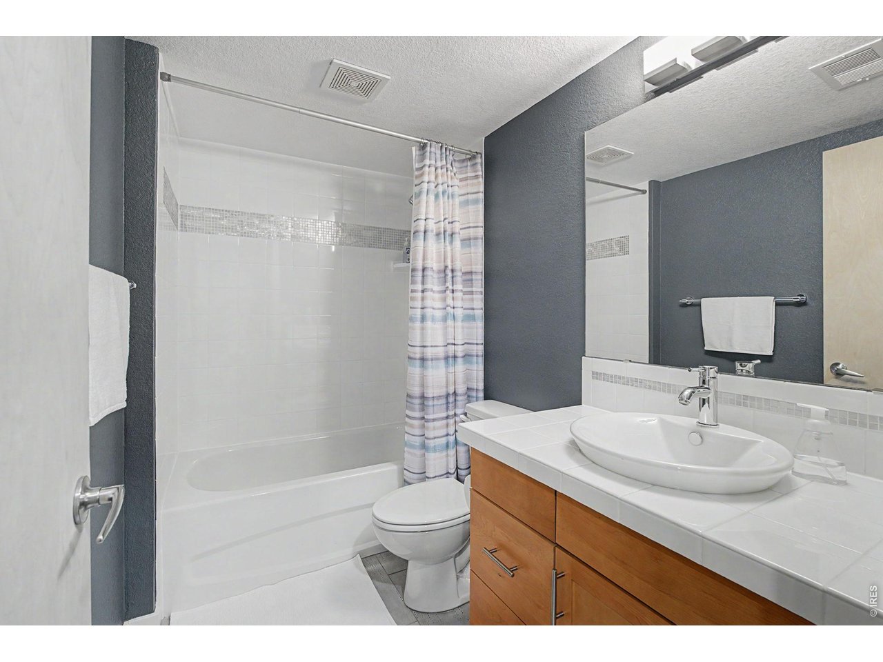 5055 Ralston Street, Unit A Boulder, CO 80304 - Photo 38 of 50 a bathroom with a sink toilet a mirror and shower