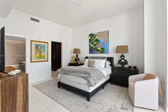 a bedroom with a large bed and a large window