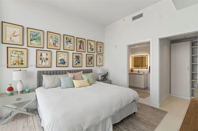 a bedroom with bed and large window