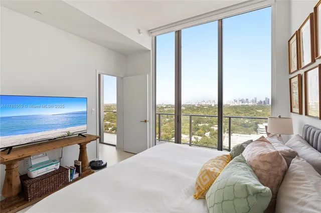 a bedroom with a bed and large window