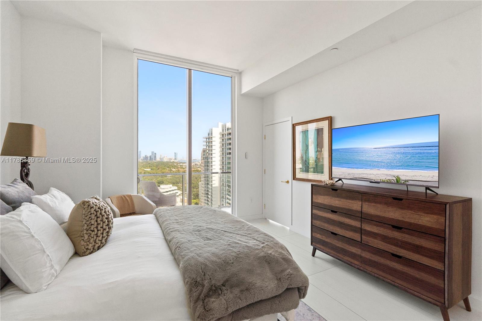 2678 Tigertail Avenue, Unit PH4 Miami, FL 33133 - Photo 19 of 75 a bedroom with a bed and a flat screen tv