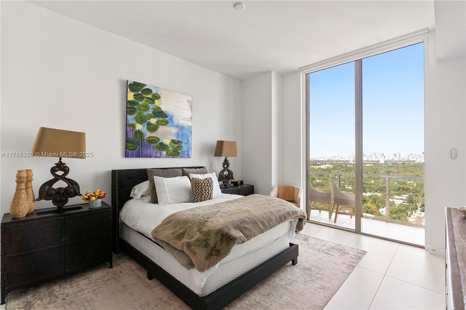 2678 Tigertail Avenue, Unit PH4 Miami, FL 33133 - Photo 22 of 75 a bedroom with bed and large window