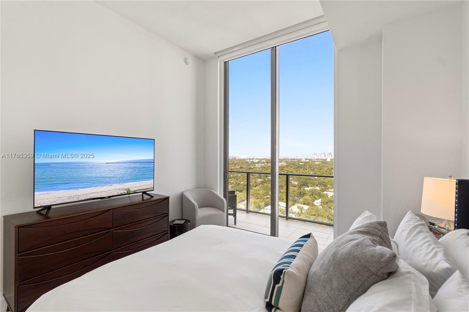 2678 Tigertail Avenue, Unit PH4 Miami, FL 33133 - Photo 23 of 75 a bedroom with a bed and large window