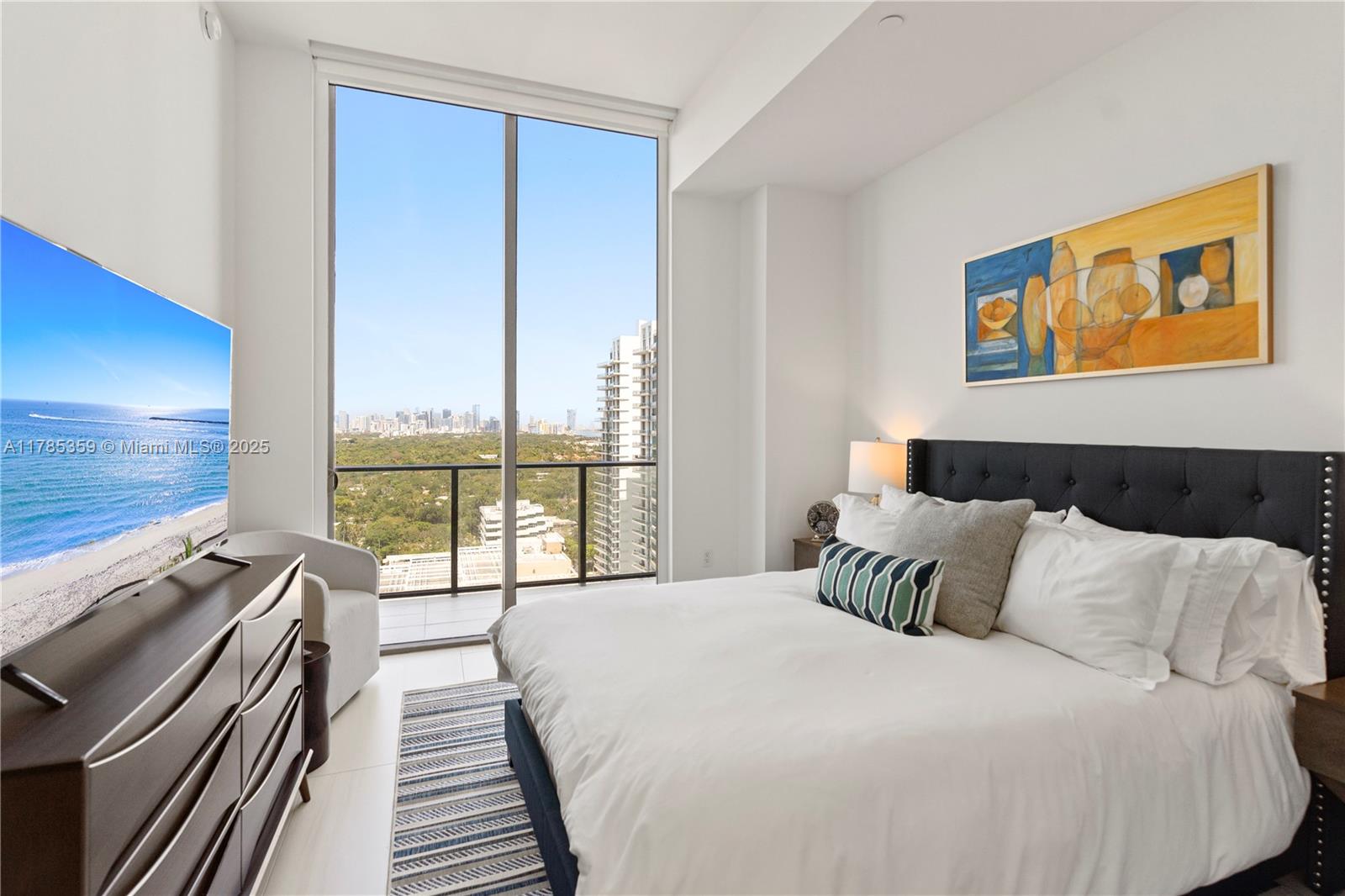 2678 Tigertail Avenue, Unit PH4 Miami, FL 33133 - Photo 25 of 75 a bedroom with a bed and wooden floor