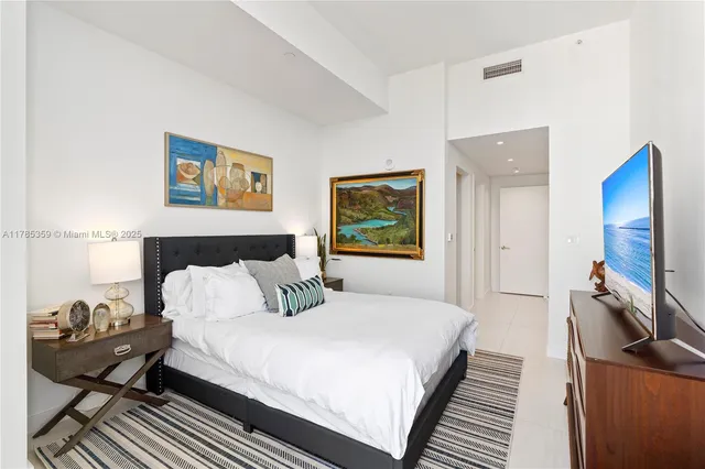 a bathroom with a double vanity sink mirror and bathtub