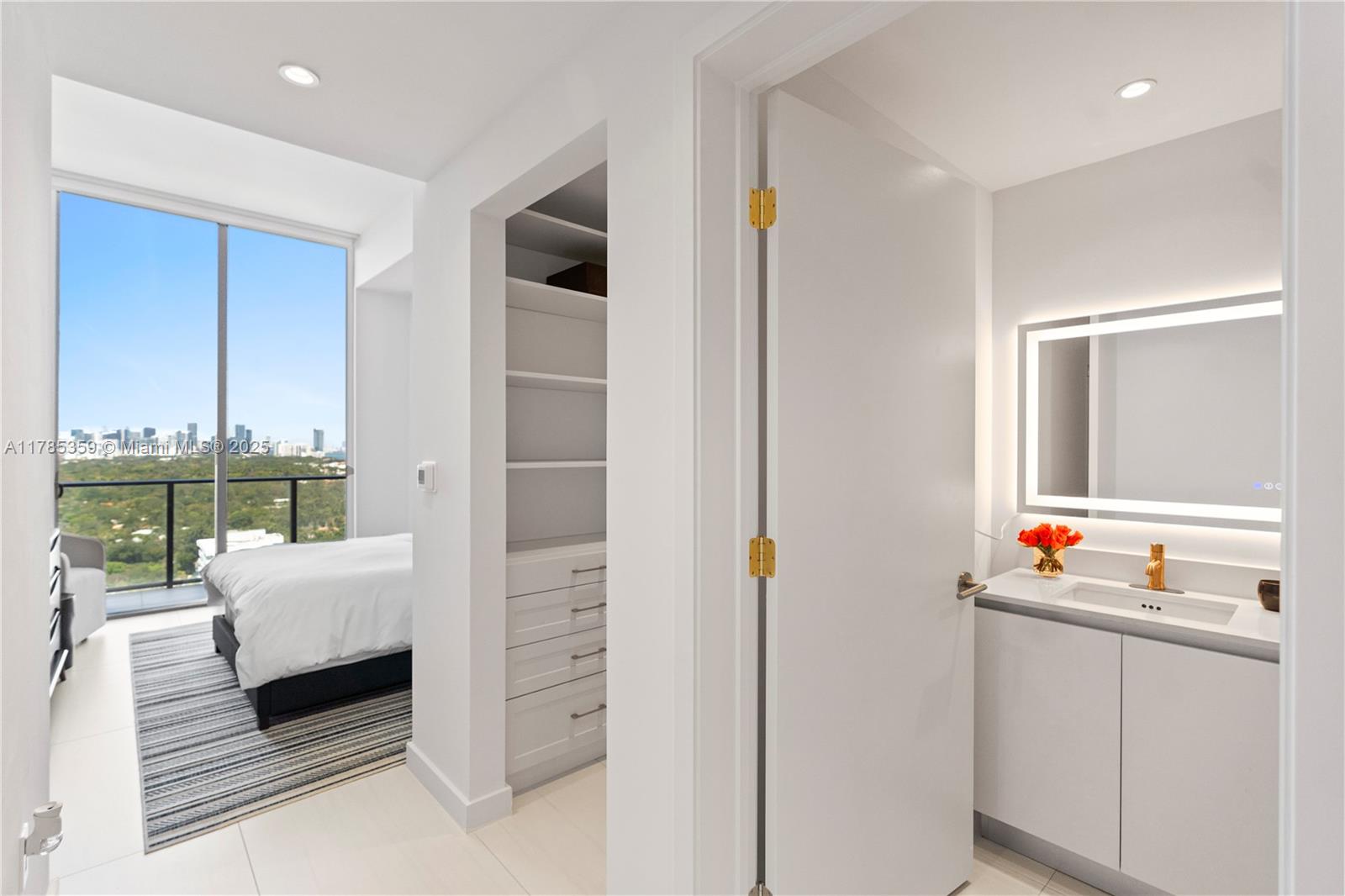 2678 Tigertail Avenue, Unit PH4 Miami, FL 33133 - Photo 35 of 75 a bedroom with furniture and a mirror