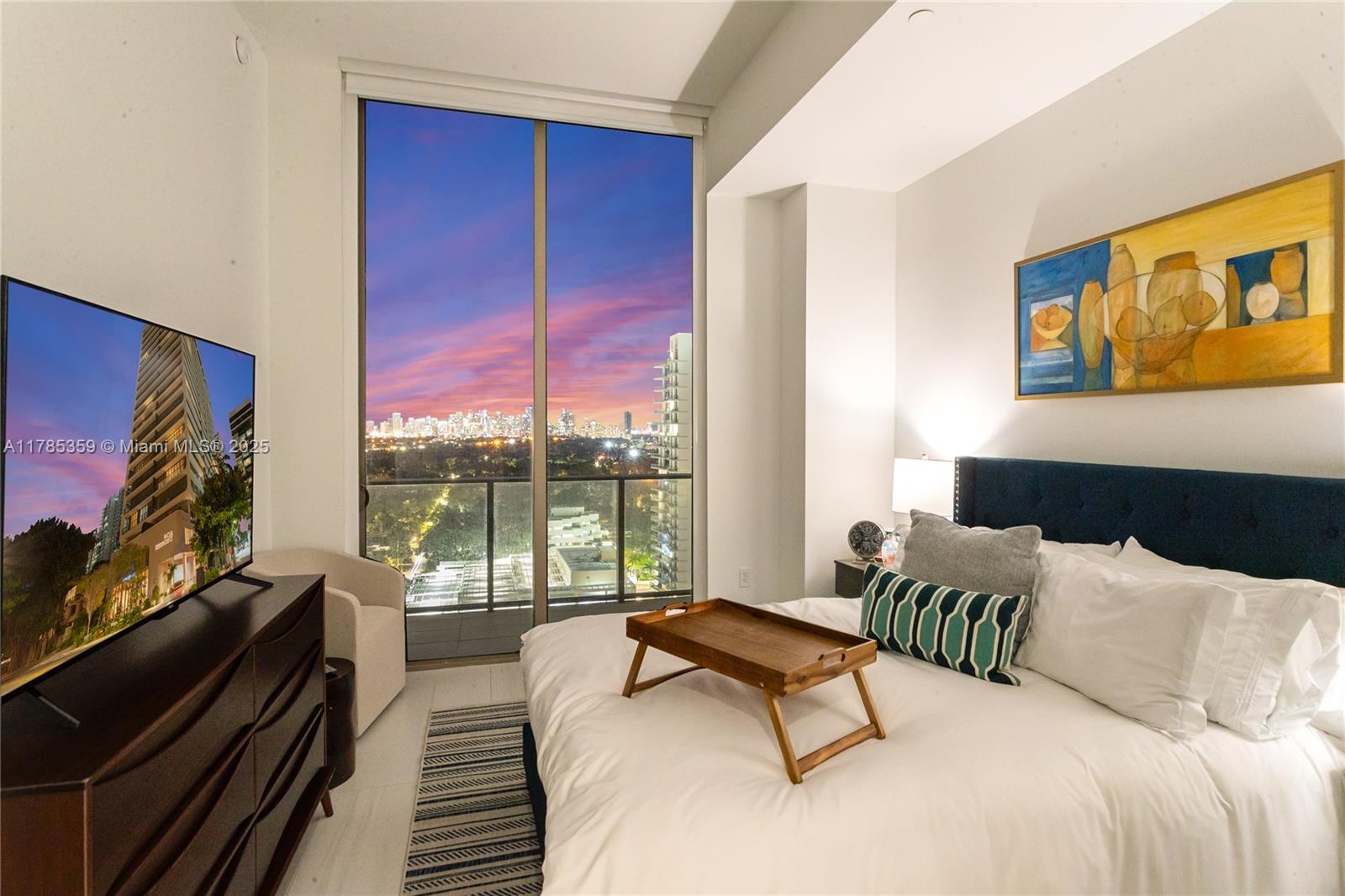 2678 Tigertail Avenue, Unit PH4 Miami, FL 33133 - Photo 63 of 75 a bedroom with furniture and a flat screen tv