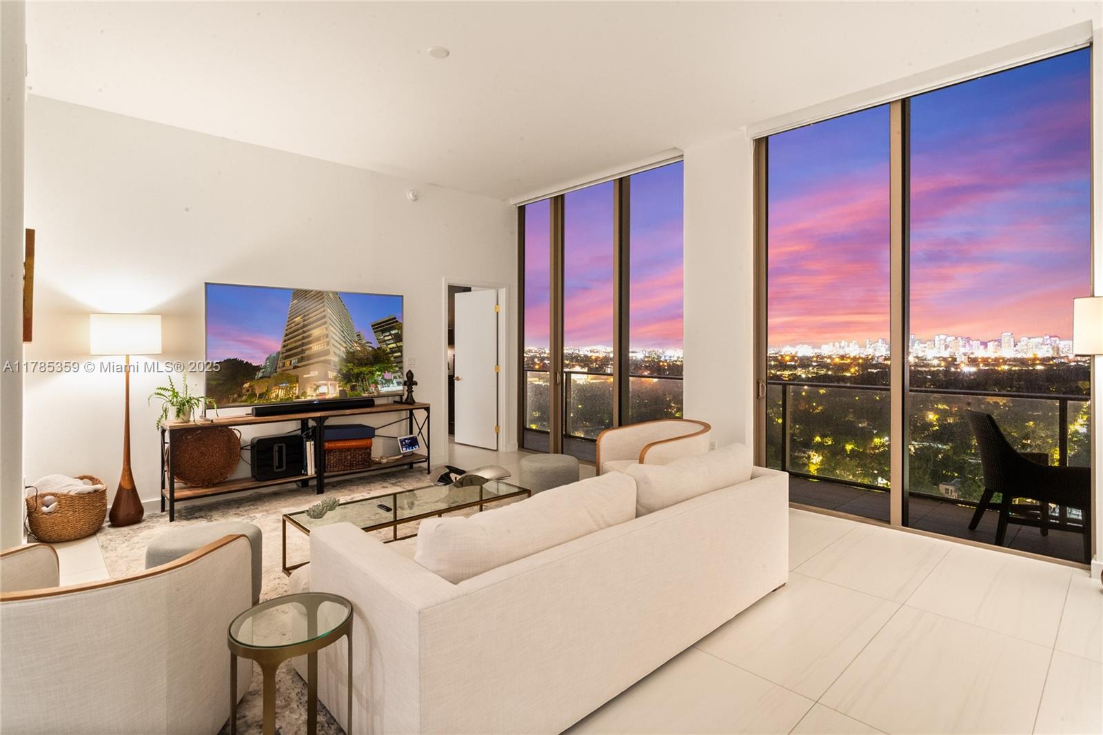 2678 Tigertail Avenue, Unit PH4 Miami, FL 33133 - Photo 70 of 75 a living room with furniture a large window and a flat screen tv