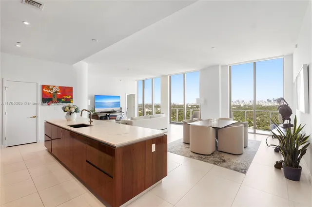 a living room with furniture a flat screen tv and a large window