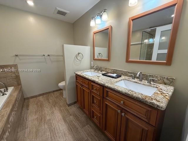 11600 Southwest 113th Place Miami, FL 33176 - Photo 14 of 21 a bathroom with a granite countertop sink a toilet and a mirror