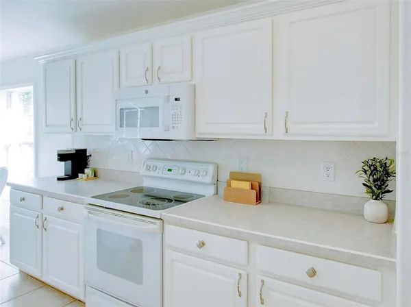 a bedroom with a bed and a refrigerator