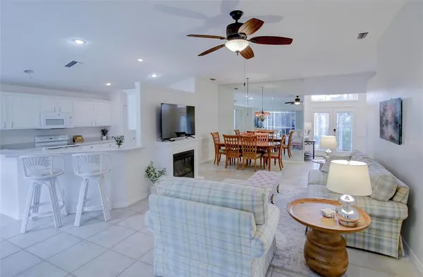 a living room with furniture and kitchen view