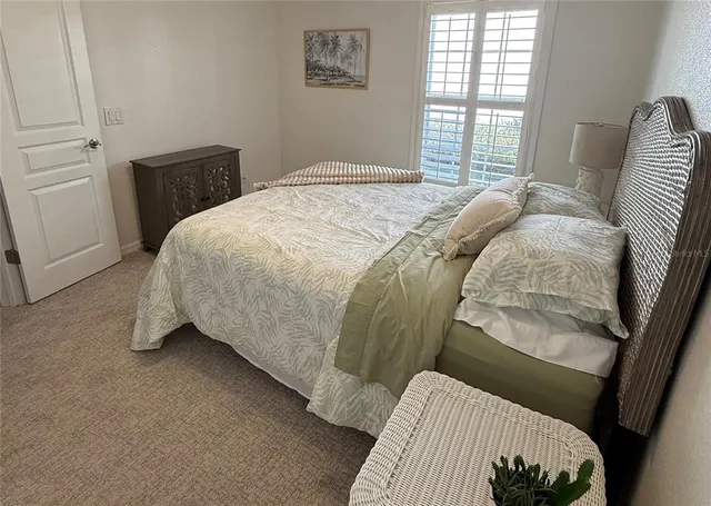 a dining room with furniture large windows and a chandelier