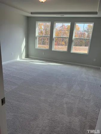 an empty room with a empty space and windows