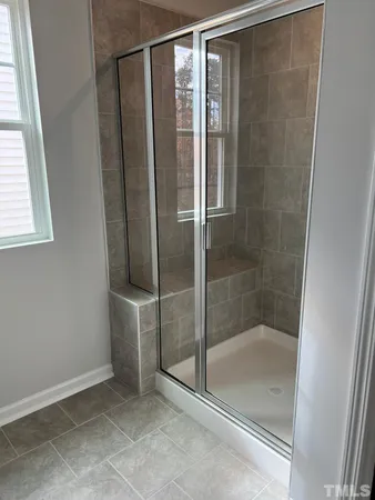 a bathroom with a glass shower door