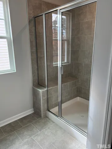 a bathroom with a glass shower door