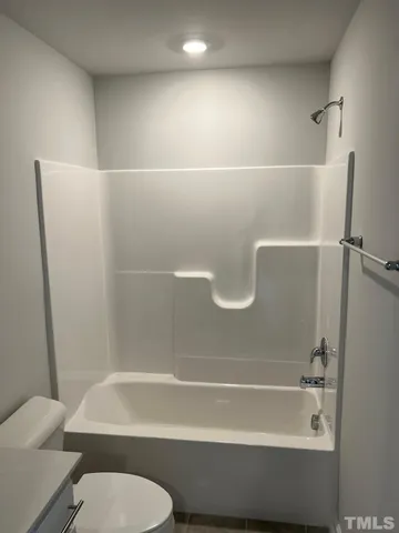 a bathroom with a shower and a toilet