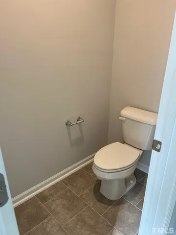 a white toilet sitting in a bathroom