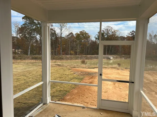 a view of a glass door and a yard from a window