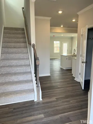 a view of entryway with wooden floor and stair