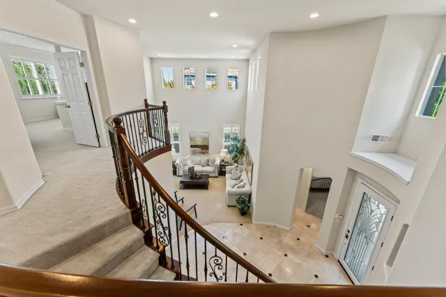 a view of a livingroom with furniture hardwood floor and stairs
