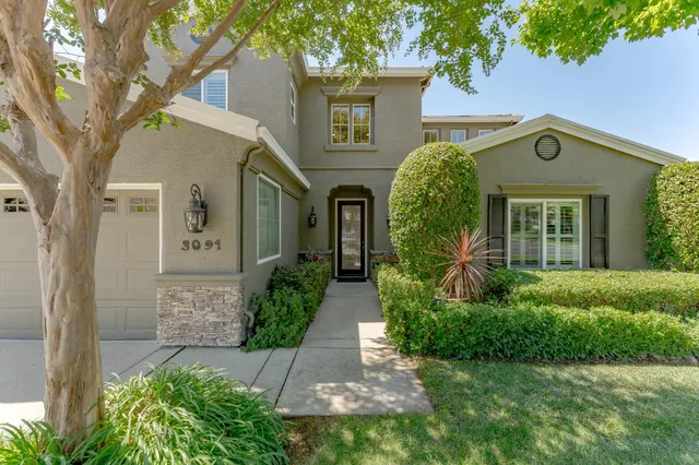 a front view of a house with garden