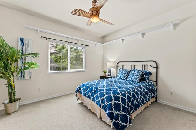 a bedroom with a bed and a potted plant