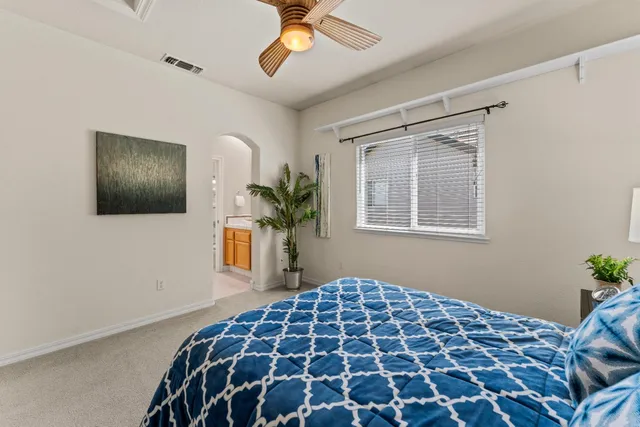 a bedroom with a bed and a potted plant