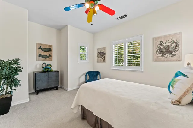 a bedroom with a bed and a potted plant