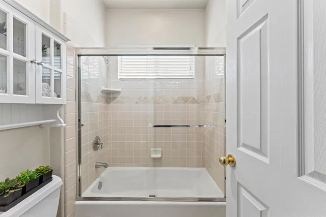 a bathroom with bathtub and shower