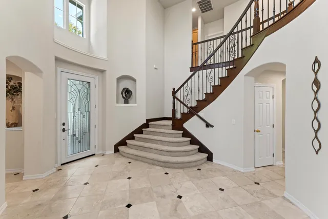 a view of entryway and hall with a front door