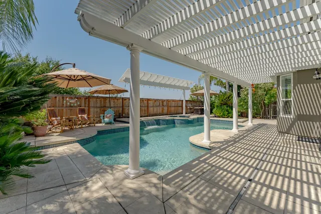 a view of a house with backyard and sitting area