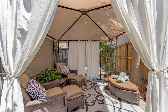 a living room with furniture and a potted plant