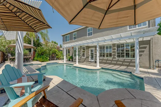 a view of a house with a yard and furniture