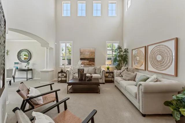 a living room with furniture and a clock