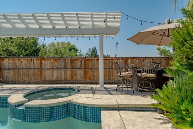 swimming pool view with a seating space