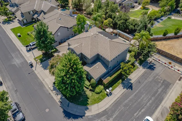 an aerial view of a house with a yard and garden