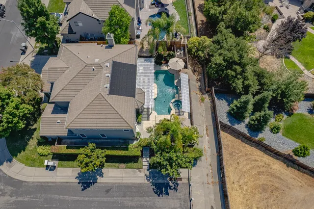 an aerial view of a house with a yard and potted plants