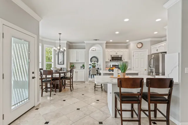 a view of a a dining room with furniture window and wooden floor