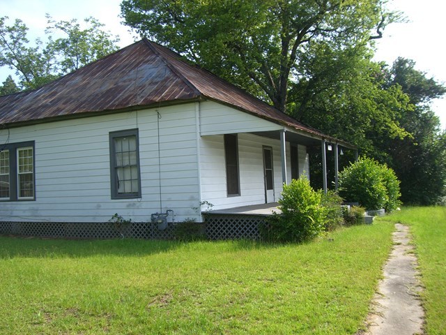3346 Millerfield Road Macon, GA 31211 - Photo 5 of 6 a view of a house with a yard plants and large tree