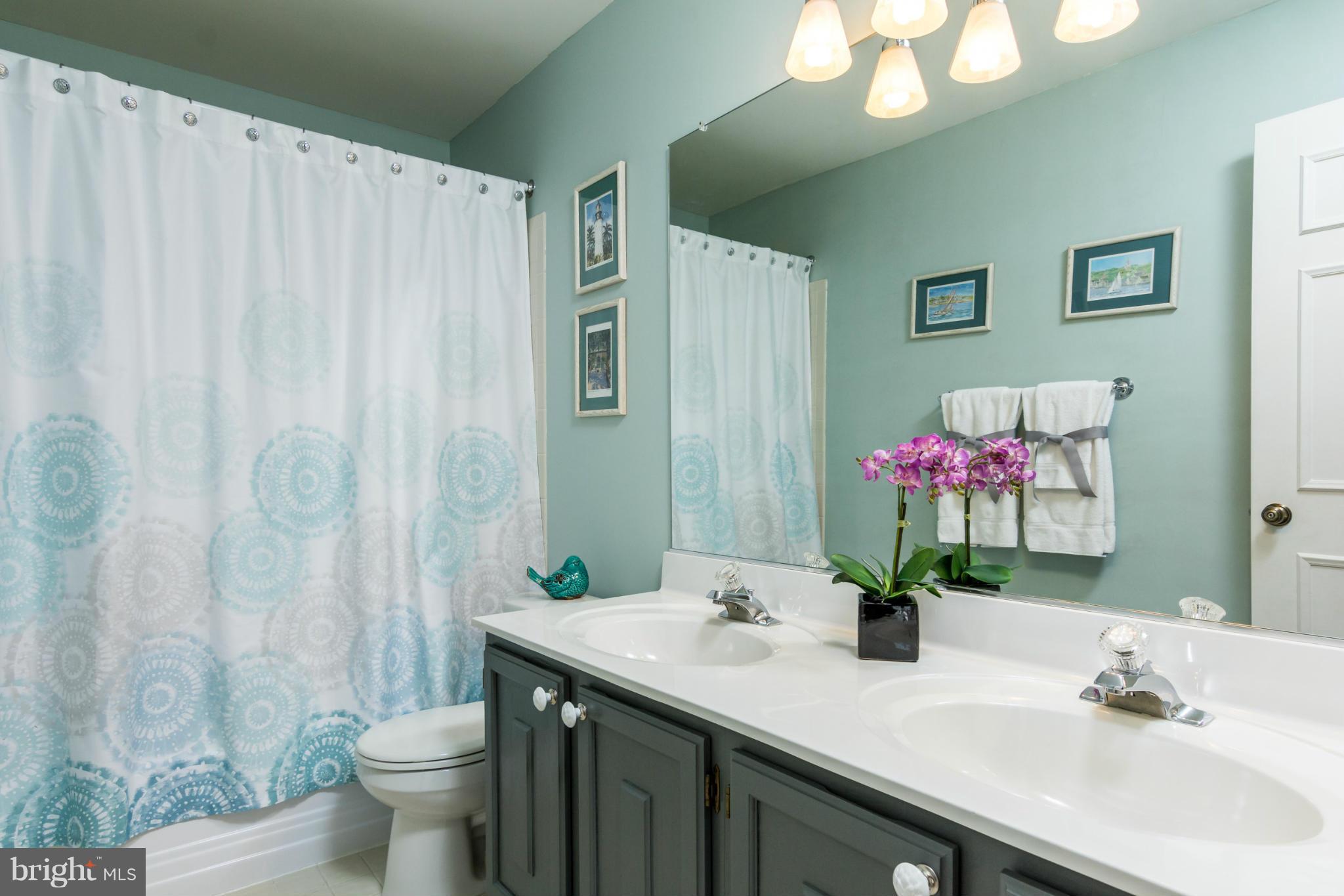 3130 Stonehenge Drive Riva, MD 21140 - Photo 20 of 30 a bathroom with a granite countertop sink a toilet and a mirror
