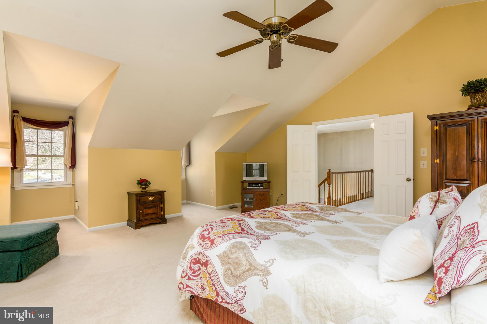 3130 Stonehenge Drive Riva, MD 21140 - Photo 23 of 30 a bedroom with a large bed and a chandelier
